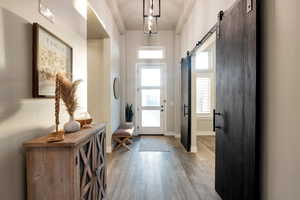 Foyer featuring a barn door and light wood-type flooring