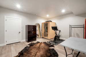 Exercise area featuring light wood-type flooring