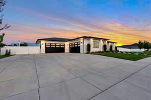 Prairie-style home with a garage and a lawn