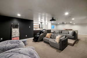 Home theater room with light colored carpet