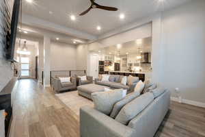 Living room featuring light hardwood / wood-style flooring and ceiling fan