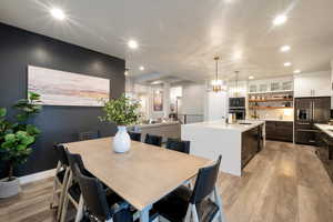 Dining area with a notable chandelier and light hardwood / wood-style floors