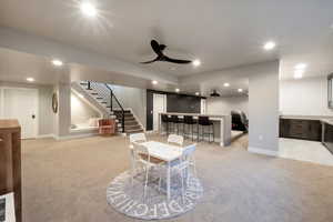 Interior space with ceiling fan and bar