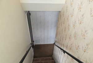 Stairway featuring carpet flooring