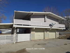 View of side of property with a garage