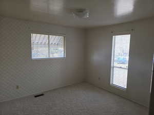 Unfurnished room featuring carpet flooring