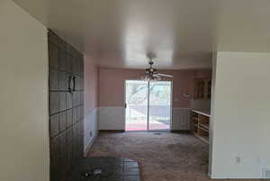 Interior space featuring ceiling fan and carpet