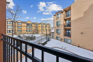 View of snow covered back of property