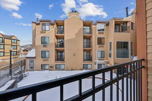 View of snow covered back of property