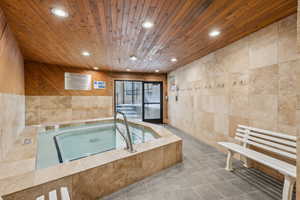 View of pool with an indoor in ground hot tub