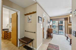 Hallway with light colored carpet