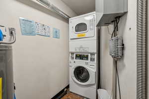 Laundry room with stacked washing maching and dryer