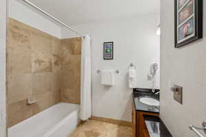 Bathroom featuring vanity and shower / tub combo