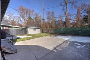 View of patio featuring an outbuilding