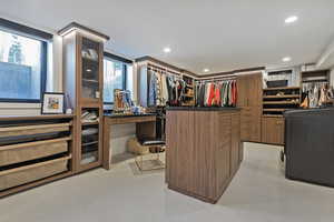 Spacious closet featuring light colored carpet