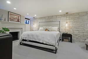 Carpeted bedroom featuring a fireplace