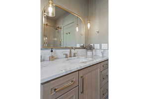 Bathroom featuring vanity and a shower