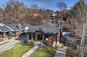 View of front of property with a front yard and covered porch