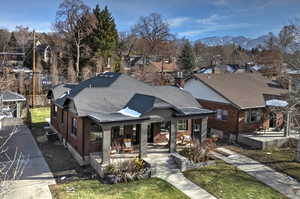 Bungalow-style home featuring a mountain view, central AC unit, and a porch