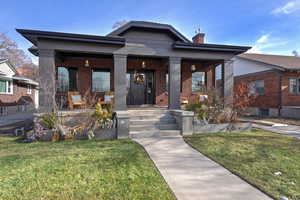 View of front of home with a front yard and a porch