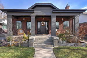 View of front of property featuring a front lawn and a porch