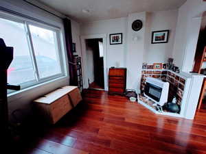 Bedroom with dark wood-type flooring and heating unit