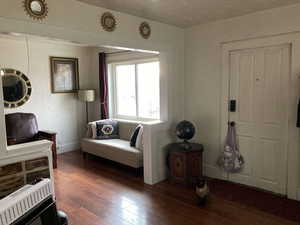 Interior space featuring heating unit and dark wood-type flooring