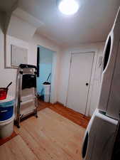 Laundry area with hardwood / wood-style floors and washer / clothes dryer