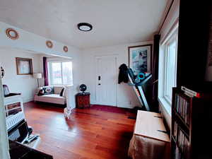 Living room featuring wood-type flooring and a textured ceiling