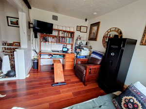 Office with dark wood-type flooring