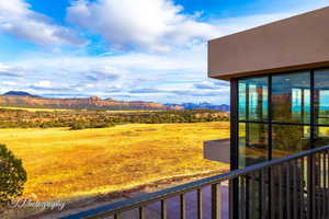 View of yard featuring a balcony and a mountain view