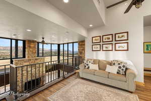 Living room featuring a textured ceiling, ceiling fan, and wood-type flooring