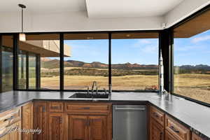 Kitchen with sink, decorative light fixtures, a wealth of natural light, and a mountain view