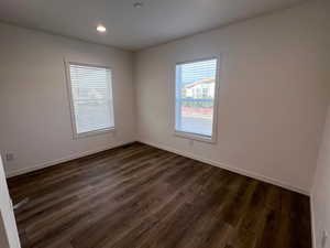 Spare room featuring dark hardwood / wood-style floors