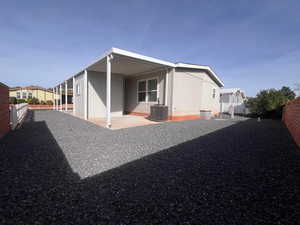 Back of property featuring central AC and a patio area