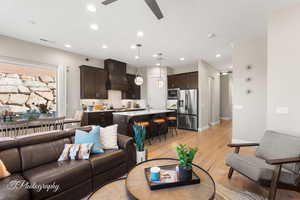 Living room with sink, light hardwood / wood-style floors, and ceiling fan