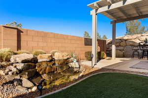 View of yard featuring a pergola and a patio