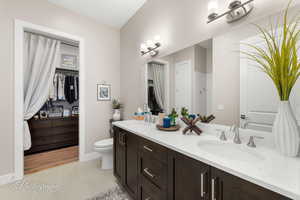 Bathroom with tile patterned flooring, vanity, and toilet