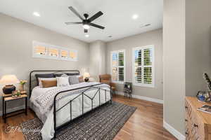 Bedroom with hardwood / wood-style floors and ceiling fan