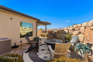 View of patio / terrace with a mountain view, central AC, and an outdoor fire pit