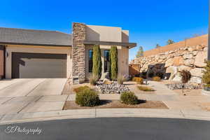 Pueblo-style home featuring a garage