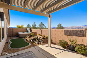 View of patio featuring a pergola and a hot tub