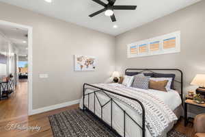 Bedroom with ceiling fan and wood-type flooring