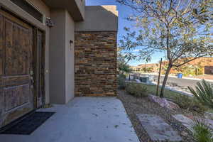 Doorway to property featuring a patio