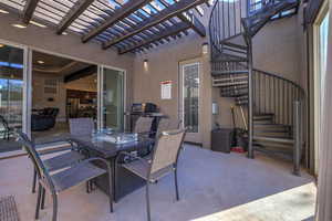 View of patio with a pergola and a grill