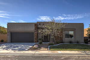 Adobe home featuring a garage