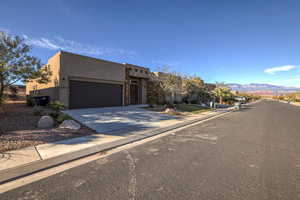 Pueblo revival-style home with a mountain view and a garage