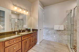 Bathroom with vanity and a shower with shower door