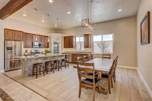 Dining room with sink and beam ceiling