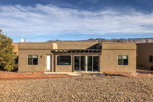 Rear view of property featuring a mountain view and a patio area